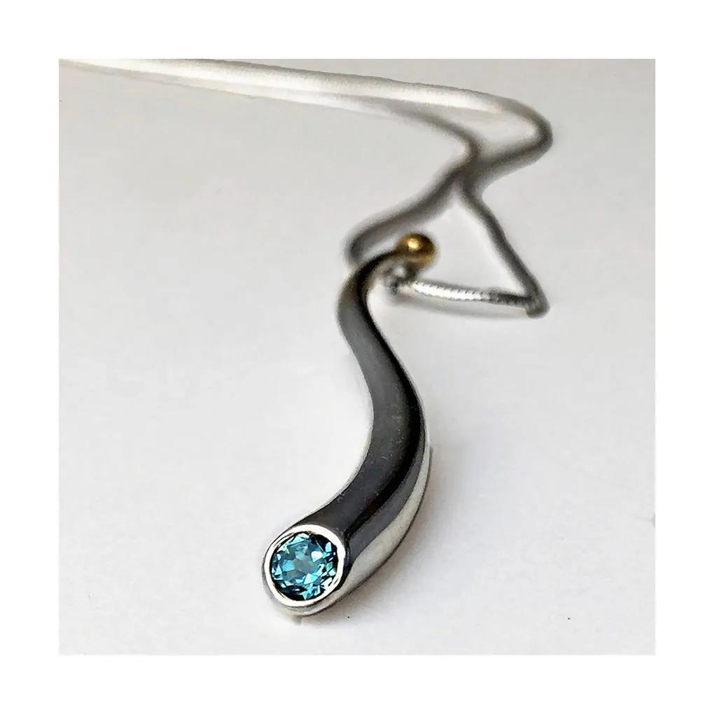 Curving silver wiggly pendant with blue topaz & 18K gold detail