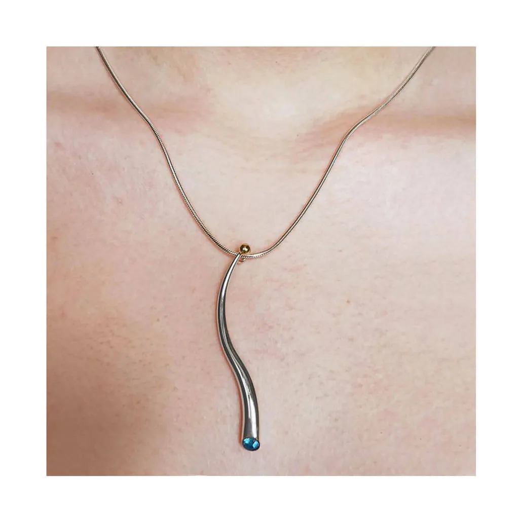 Curving silver wiggly pendant with blue topaz & 18K gold detail